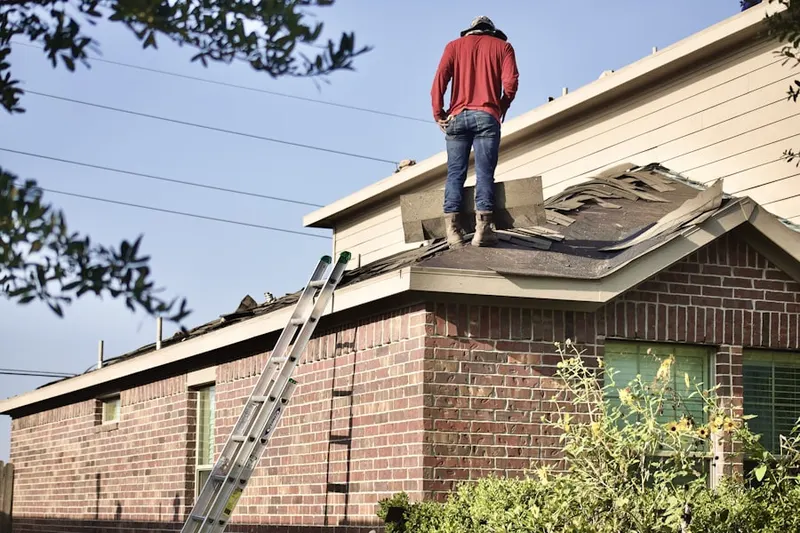 Professional roofer working on a residential roof in Winthrop